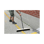 man using natural wood block broom brush with black and green brissels to clean outdoor pavement,4484,4485